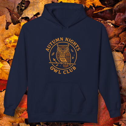 Navy blue hoodie with 'Autumn Nights Owl Club' design on a background of autumn leaves.