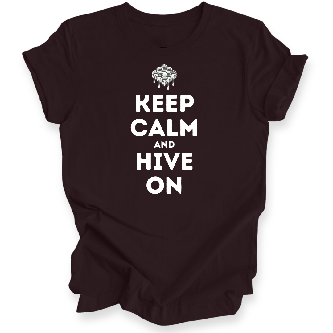 A dark brown short-sleeve t-shirt with a white graphic print that reads 'KEEP CALM AND HIVE ON' under a dripping honeycomb icon, displayed on a clean white background.
