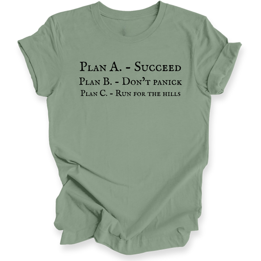 A sage green short-sleeve crewneck t-shirt with black printed text on the front reading 'PLAN A. - SUCCEED PLAN B. - DON'T PANICK PLAN C. RUN FOR THE HILLS'