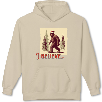 Beige hoodie with a graphic of a Santa Claus bigfoot and 'I Believe' text on a white background