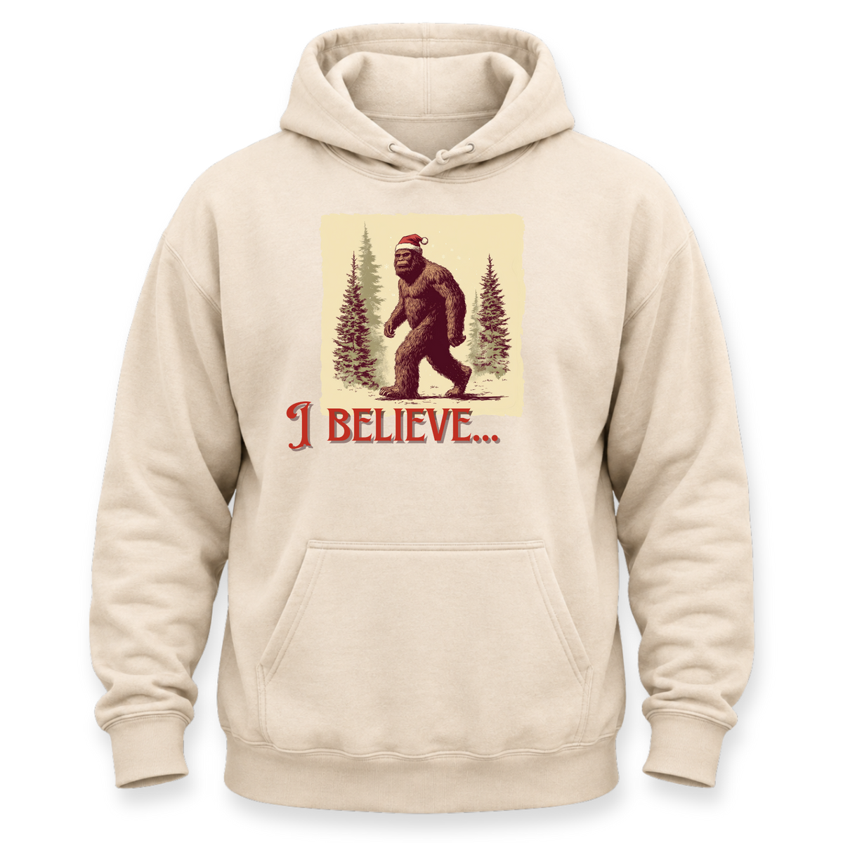 A beige pullover hoodie with a front graphic of a Bigfoot figure wearing a Santa hat among pine trees, with the text 'I BELIEVE.