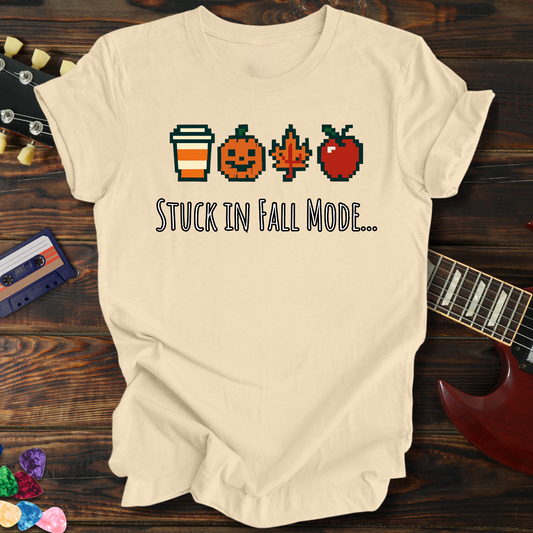 Beige t-shirt with fall-themed graphics and text on a wooden surface with a guitar and cassette tape.