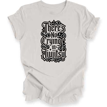 A light beige short-sleeve crewneck t-shirt with a black gothic-style graphic text print reading 'There's No Crying in JiuJitsu' on the front, displayed against a clean white background.