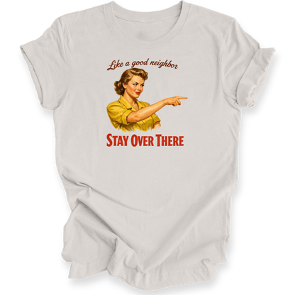 A light gray graphic t-shirt featuring a vintage-style illustration of a woman in a yellow shirt pointing, with the text 'Like a good neighbor' above and 'STAY OVER THERE' below in red.