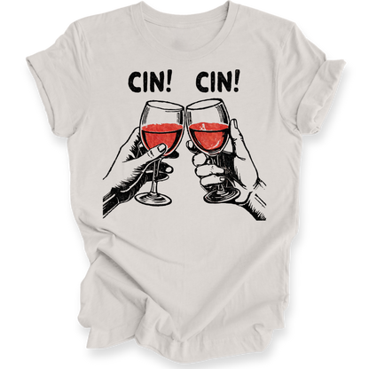 A light beige crewneck t-shirt with a graphic print of two hands clinking glasses of red wine under the text 'CIN! CIN!'.
