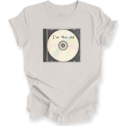 A light beige crewneck t-shirt with a graphic of a CD case containing a CD that reads 'I'm this old' in black text.