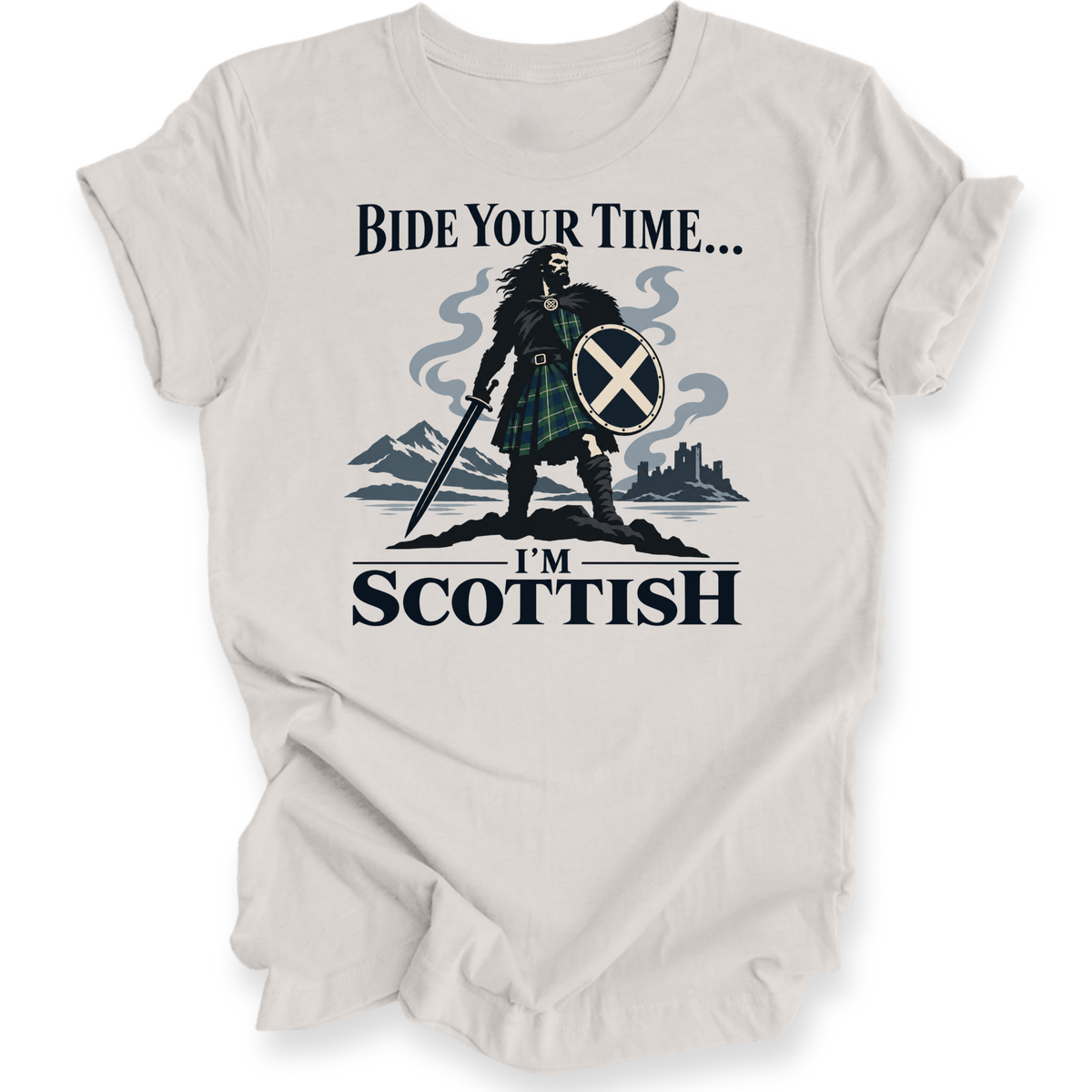 A light beige crewneck t-shirt with a graphic print of a Scottish warrior in a tartan kilt holding a sword and shield, with the text 'BIDE YOUR TIME.