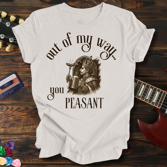 White t-shirt with graphic design and text on a wooden surface with a guitar and cassette tape.