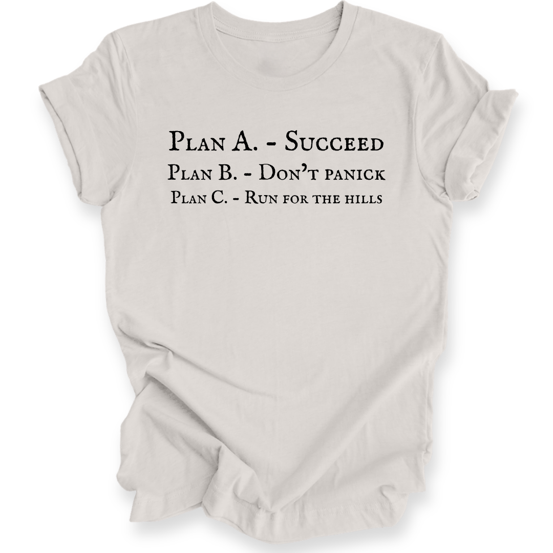 A light beige crewneck short-sleeve t-shirt with black printed text on the front reading 'PLAN A. - SUCCEED PLAN B. - DON'T PANICK PLAN C. RUN FOR THE HILLS'