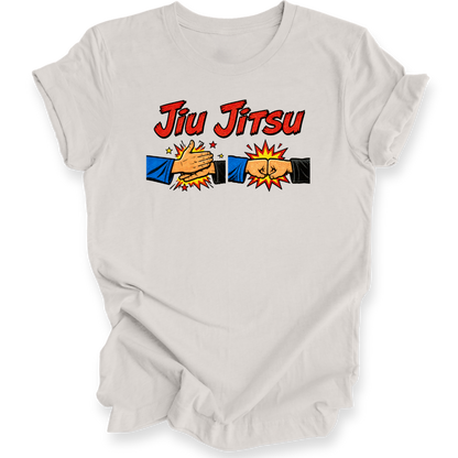 A light gray short-sleeve t-shirt with a 'Jiu Jitsu' graphic on the chest, featuring two cartoon hands in blue and black sleeves clashing with yellow stars and an explosion effect.