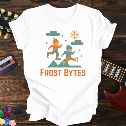 White t-shirt with 'Frost Bytes' graphic design on a wooden surface with a guitar and cassette tape.