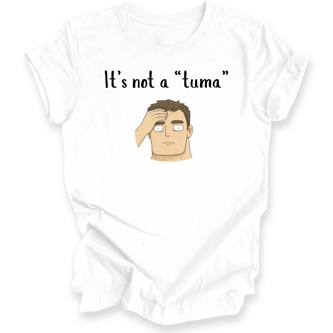 A white short-sleeve crewneck t-shirt with a graphic print on the front. The print features the black text 'It's not a "tuma"' above a cartoon illustration of a man with brown hair, a beige face, and white eyes holding his hand to his forehead.