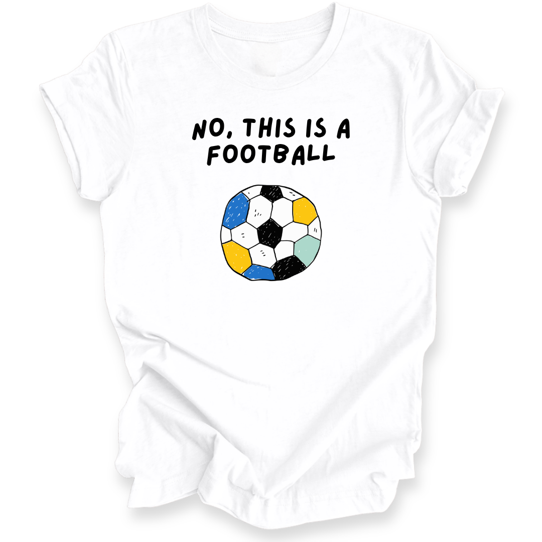 A white short-sleeve t-shirt with a graphic print that reads 'NO, THIS IS A FOOTBALL' above a stylized soccer ball made of multicolored hexagons, shown on a plain white background.