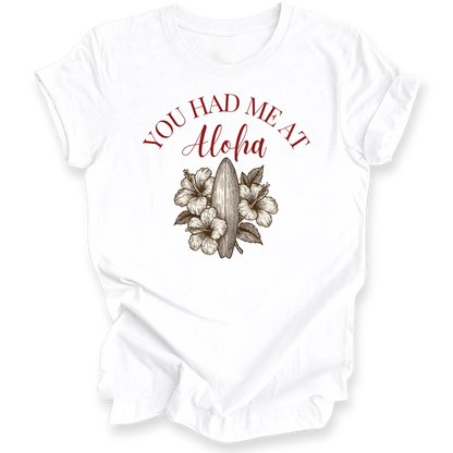 White t-shirt with red text 'YOU HAD ME AT Aloha' and floral design on a white background
