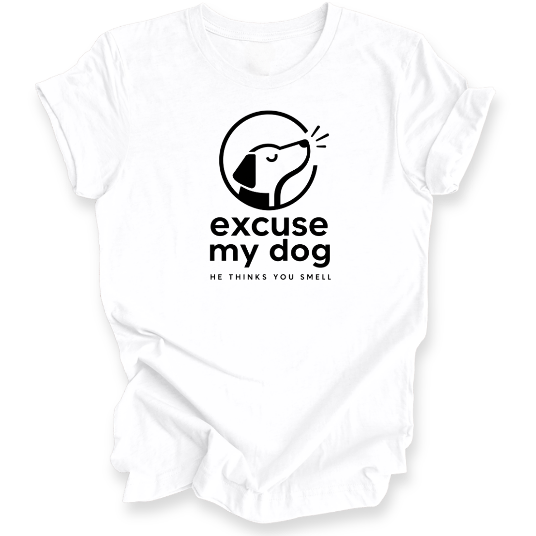 A white short-sleeve crewneck t-shirt with a black graphic print on the chest. The graphic features a stylized dog head inside a circle with the text 'excuse my dog' and 'HE THINKS YOU SMELL' underneath.