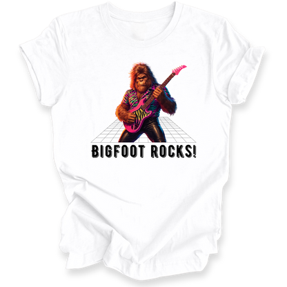 White t-shirt with a graphic of a rock-playing bigfoot and 'BIGFOOT ROCKS!' text on a white background