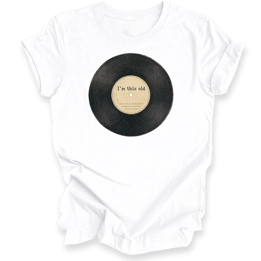 A white short-sleeve crewneck t-shirt featuring a graphic of a black vinyl record with a beige center label that reads 'I'm this old'.