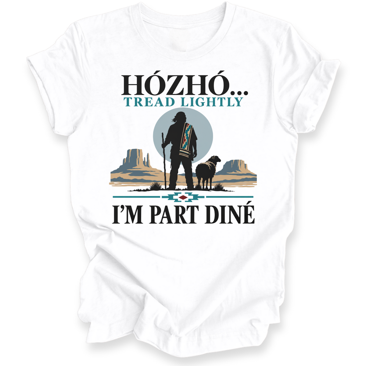 A white short-sleeve t-shirt with a graphic print on the front. The design features a Native American-style silhouette standing with a staff next to a sheep, set against a desert landscape with mesas and a large gray circle.