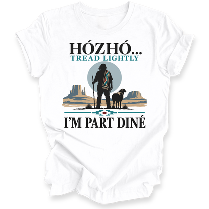 A white short-sleeve t-shirt with a graphic print on the front. The design features a Native American-style silhouette standing with a staff next to a sheep, set against a desert landscape with mesas and a large gray circle.