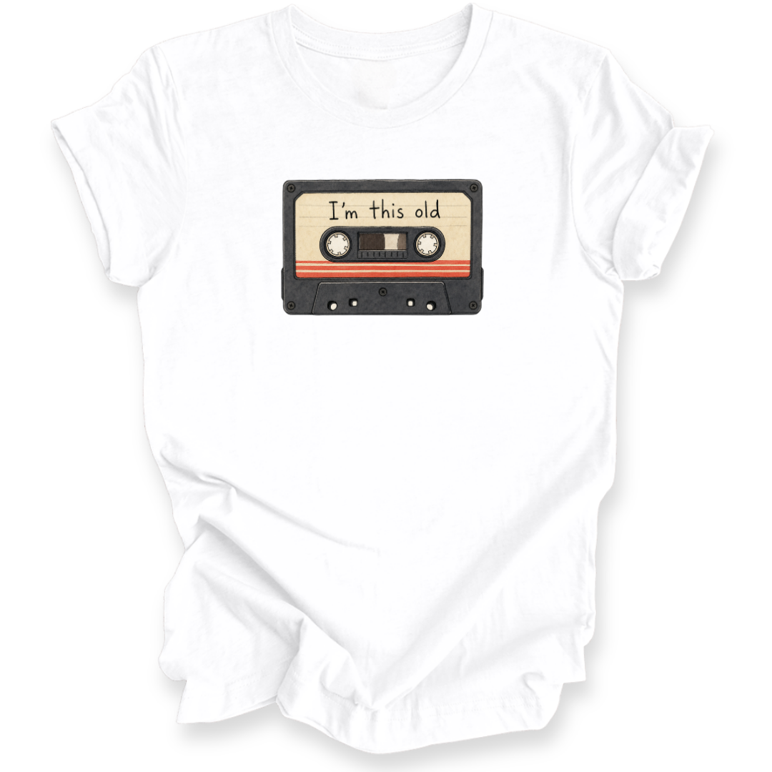 A white short-sleeve crewneck t-shirt featuring a graphic of a vintage cassette tape with the text 'I'm this old' printed on the label.