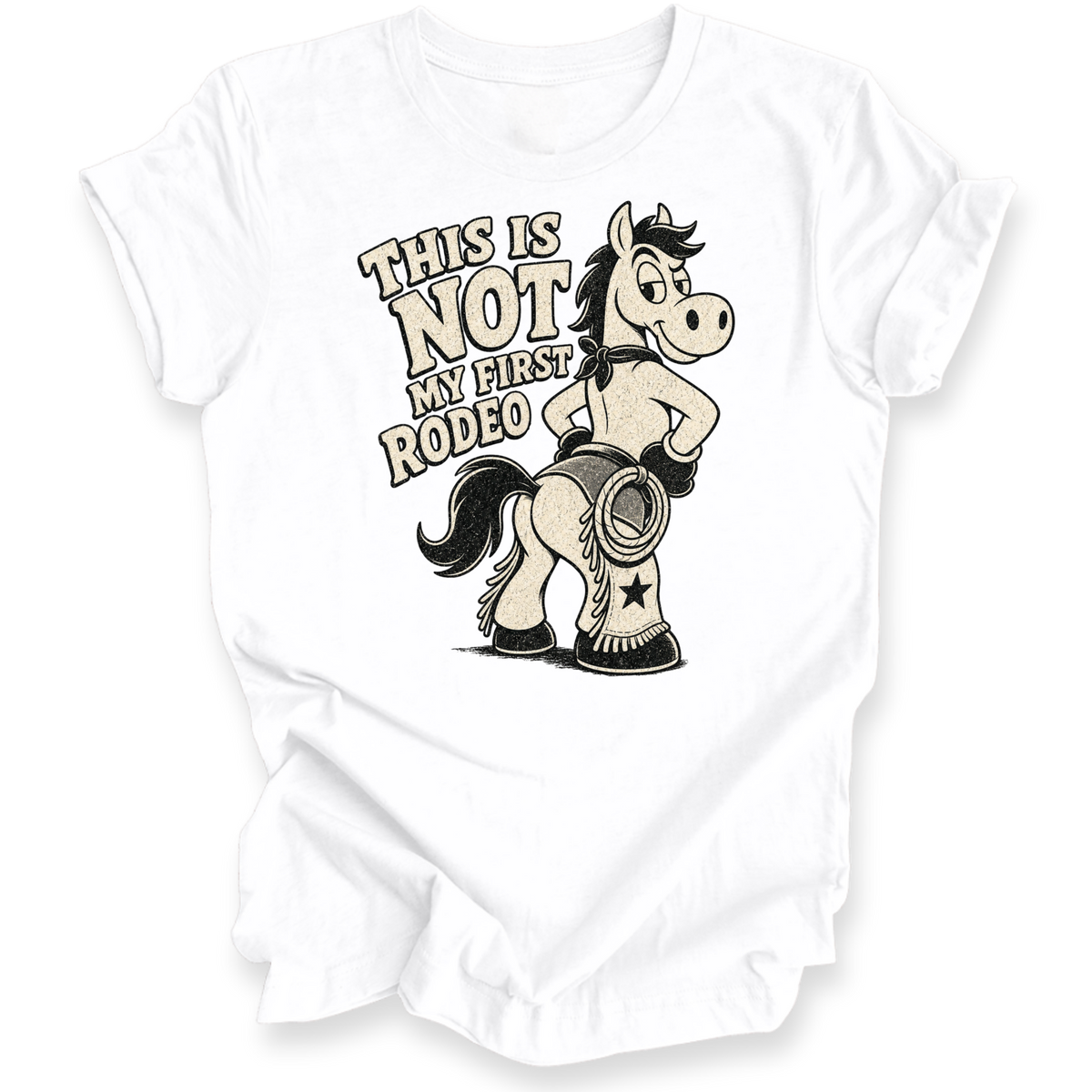 A white short-sleeve t-shirt with a graphic print of a cartoon horse wearing chaps and boots, next to the text 'THIS IS NOT MY FIRST RODEO'.