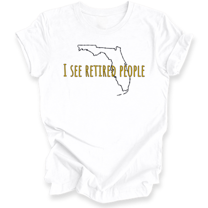 A white short-sleeve crewneck t-shirt with a graphic of the state outline of Florida in black, with the text 'I SEE RETIRED PEOPLE' written across it in a textured gold font.